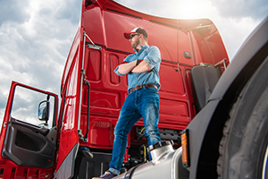 proud trucker and his brand new semi truck tractor G2EJTS8