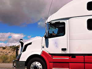 transportation and logistics a red and white big rig diesel tractor truck on the road under stormy t20 Xz4kG3