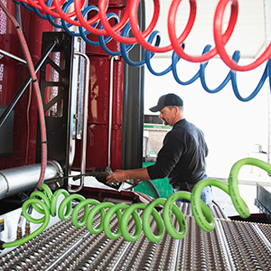 view of a driver putting gas in a commercial truck 2022 03 04 02 09 17 utc